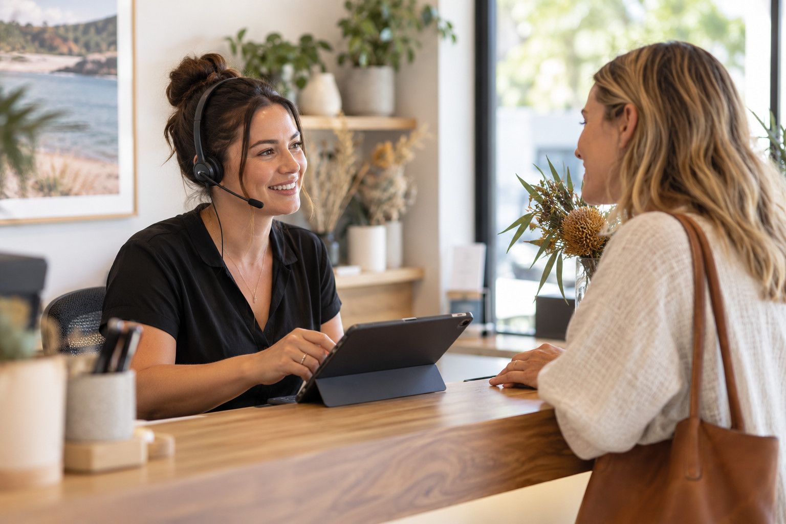 Front-desk team member with a headset helping a customer